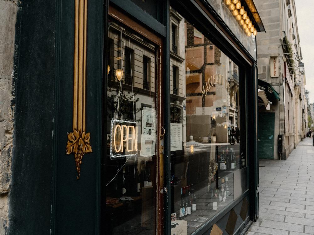 An illuminated open sign in a shop doorway.